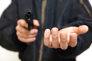man holding gun threatening victim