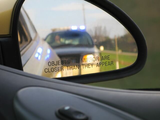 Police car in rear view mirror
