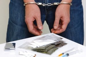 man in handcuffs for possession of cocaine 