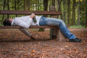 man passed out on bench