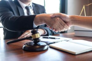 An attorney giving a client a handshake.